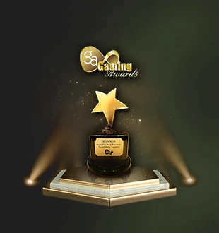 A gold trophy shaped like a star, placed on a pedestal with the word 'WINNER' inscribed on it, illuminated by spotlights displayed above against a green background.